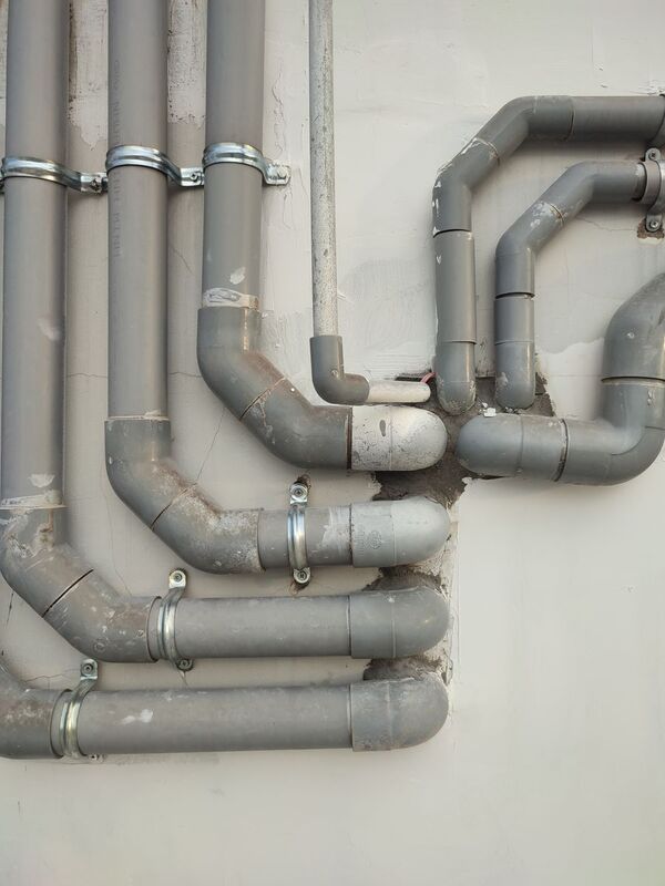 Metal water pipes along a wall